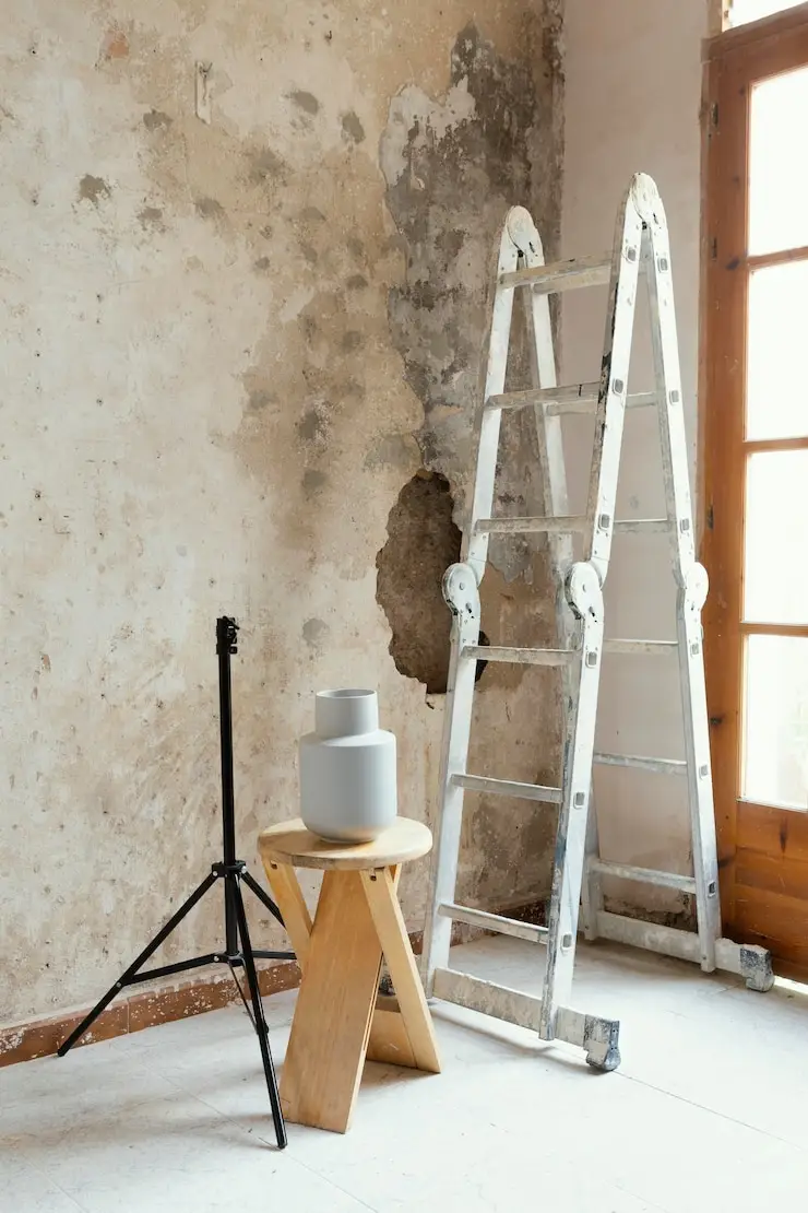 Ladder and tools in a room with water damage and mold for Cleanup-Service-And-Restoration.