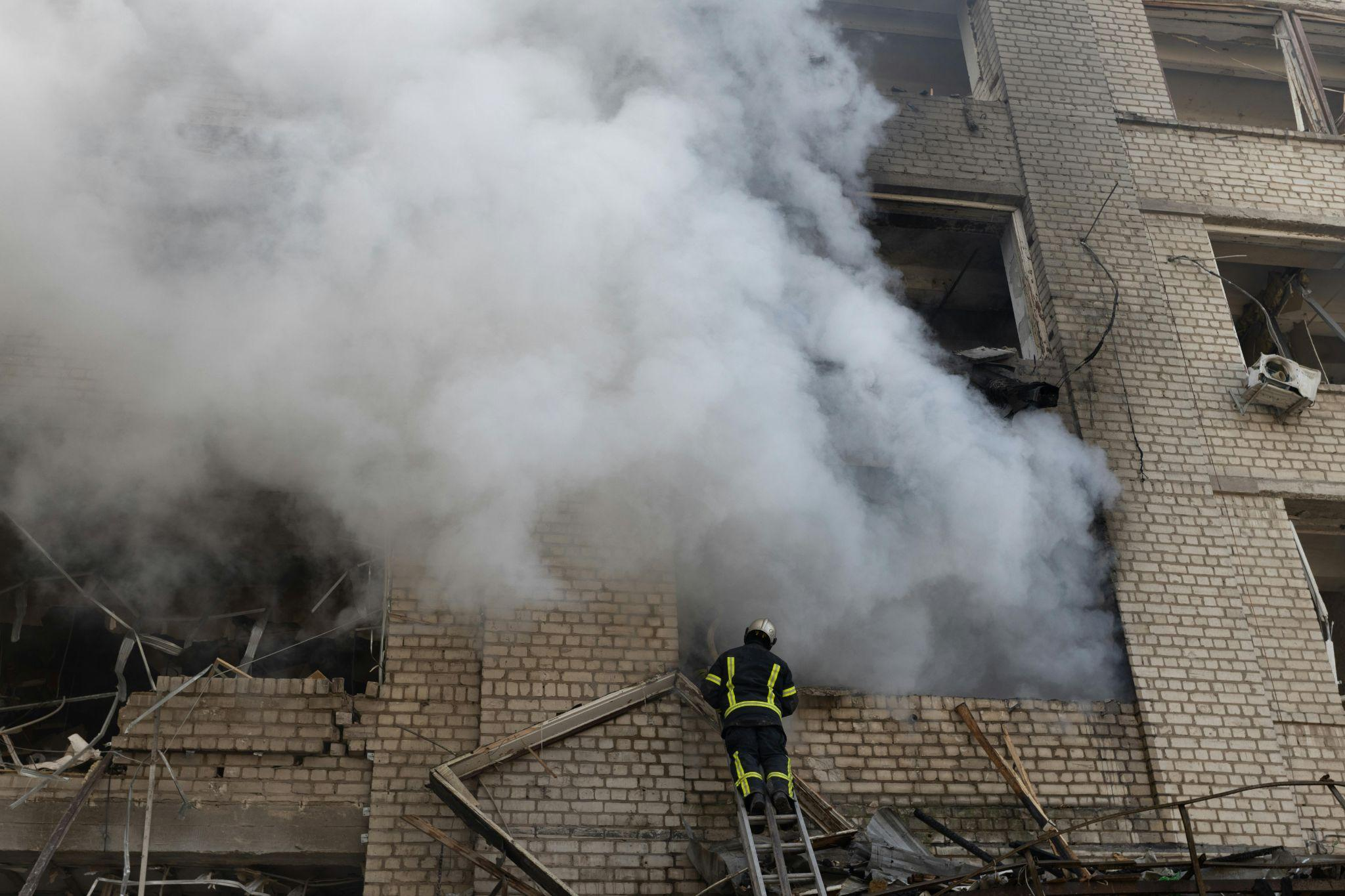 A person on a ladder working in smoke