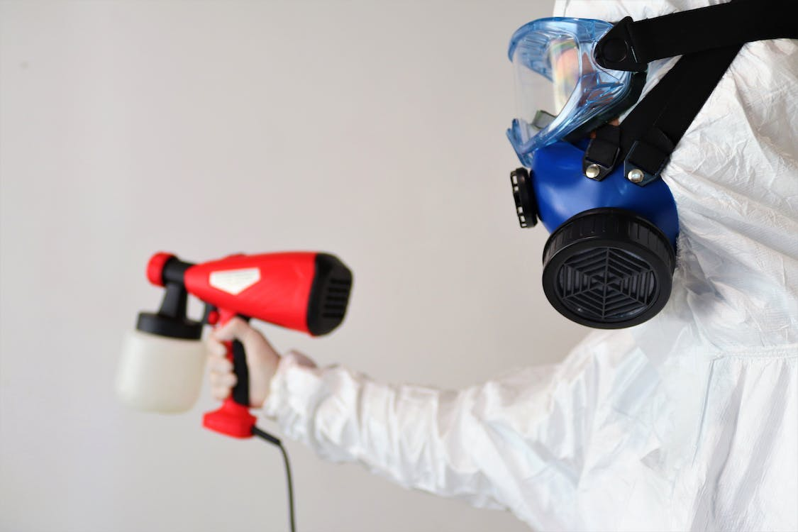 A photo of a person wearing a PPE suit and mask